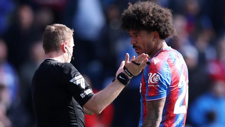 Chris Richards protests after receiving a red card from referee Samuel Barrott 