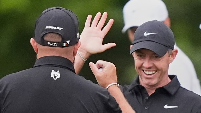 Rory McIlroy, of North Ireland, facing, reacts with teammate Shane Lowry, of Ireland, after Lowry's birdie putt on the 10th hole during the first round of the PGA Zurich Classic golf tournament at TPC Louisiana in Avondale, La., Thursday, April 24, 2025. (AP Photo/Gerald Herbert) 