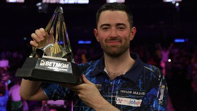 Luke Humphries poses with the trophy after beating Luke Littler in the Premier League Darts final