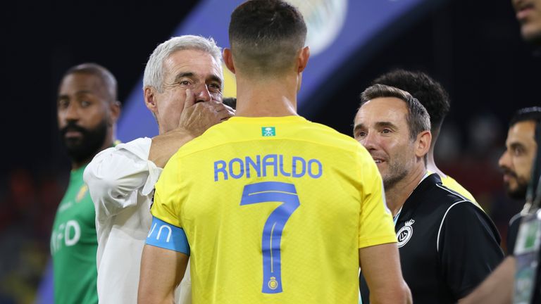 Al Nassr's Cristiano Ronaldo, listens to his coach Luis Castro, left, during the Arab Club Champions Cup at King Fahd Stadium in Taif, Saudi Arabia, Saturday, Aug.12, 2023. (AP Photo/Samah Zidan)