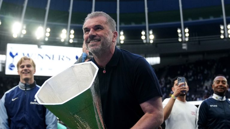 Tottenham Hotspur manager Ange Postecoglou with the UEFA Europa League trophy on the pitch after the Premier League match at the Tottenham Hotspur Stadium, London. Picture date: Sunday May 25, 2025.
