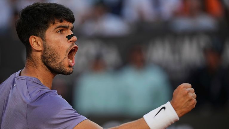 Carlos Alcaraz of Spain, reacts after scoring a point against Jannik Sinner of Italy during their final tennis match in the Italian Open at the Foro Italico in Rome, Sunday, May 18, 2025. (AP Photo/Alessandra Tarantino)
