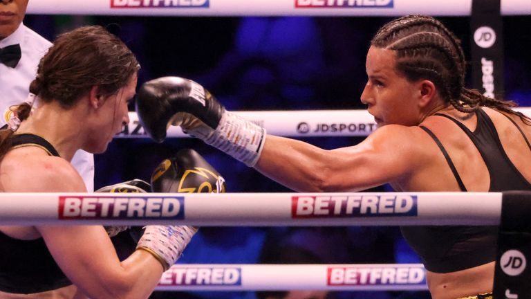 Britain's Chantelle Cameron, right, lands a punch on Ireland's Katie Taylor during their light-welterweight boxing world title fight at the 3Arena in Dublin, Ireland, Saturday, May 20, 2023.(AP Photo/Peter Morrison)