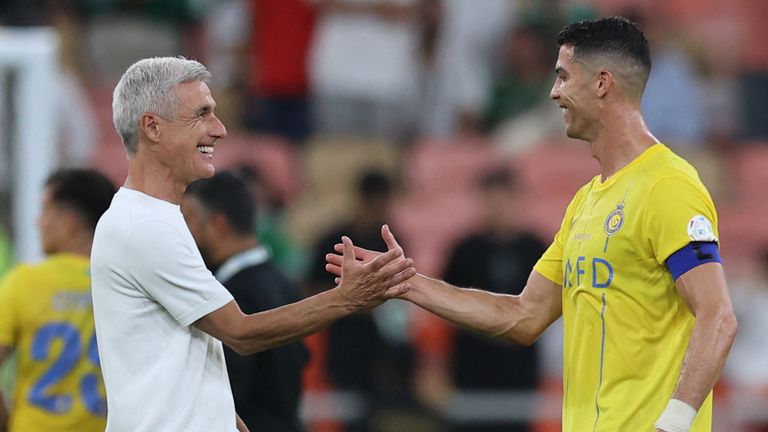 Nassr's Portuguese forward #07 Cristiano Ronaldo celebrates with his coach Luis Castro after the Saudi Pro League football match between Al-Ahli and Al-Nassr at the King Abdullah Sport City Stadium in Jeddah on March 15, 2024. (Photo by AFP)
