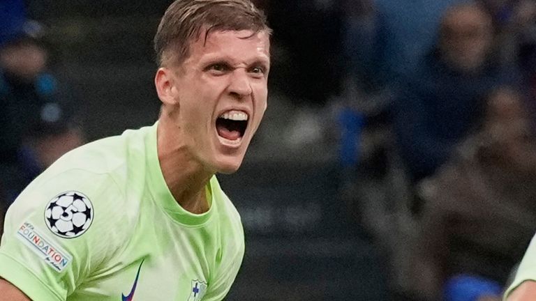 Barcelona's Dani Olmo, left, celebrates with his teammate Eric Garcia after scoring his side's second goal during the Champions League semifinal second leg soccer match between Inter Milan and Barcelona at San Siro stadium in Milan , Italy, Tuesday, May 6, 2025. (AP Photo/Luca Bruno)