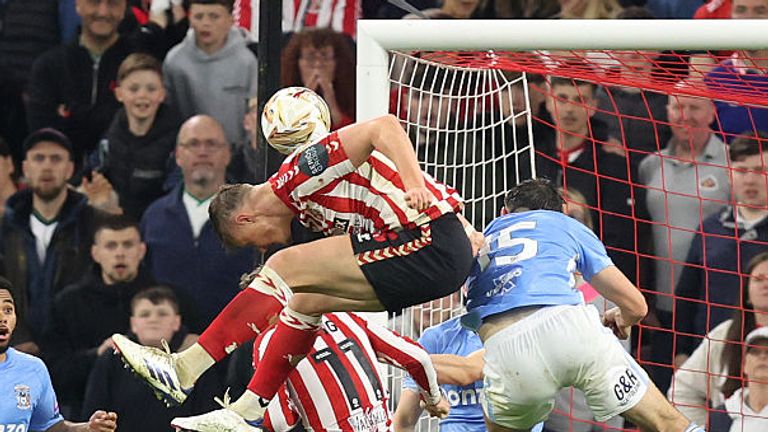 Ballard rose highest from the corner in the final minute of extra-time