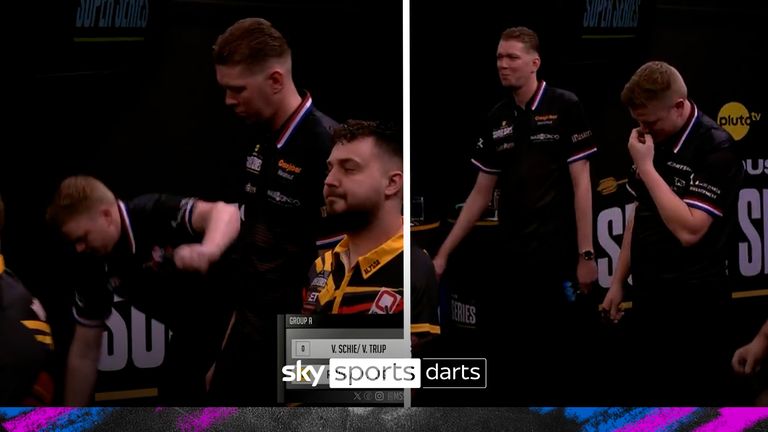Players break out in laughter as Danny van Trijp falls off the stage after pinning a 137 checkout.