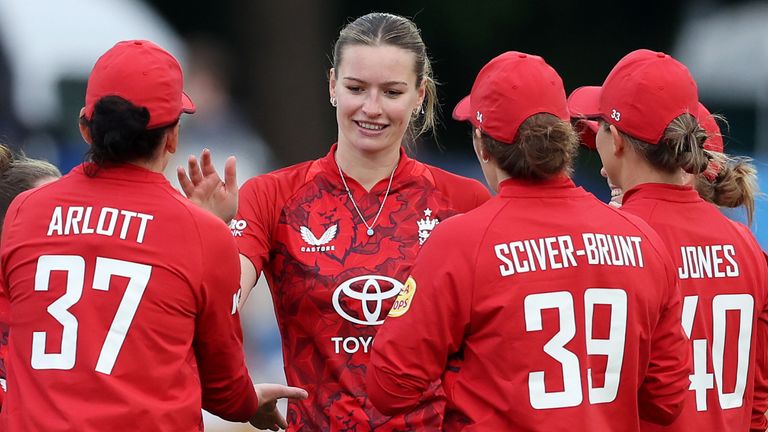 England congratulate Lauren Bell on taking a wicket in the first T20 against West Indies