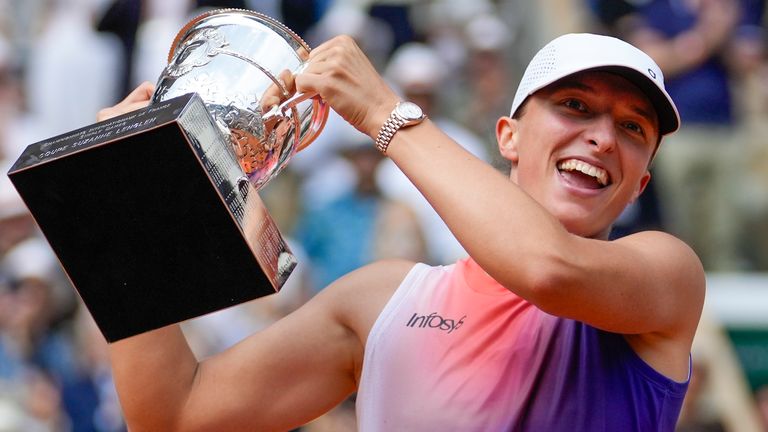 Iga Swiatek holds the trophy after winning the women's final of the French Open tennis tournament against Italy's Jasmine Paolini at the Roland Garros stadium in Paris, France, June 8, 2024. (AP Photo/Thibault Camus, File)