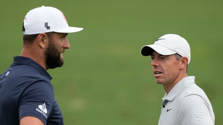 Jon Rahm, left, of Spain, talks with Rory McIlroy, of Northern Ireland, on the practice range during a practice round in preparation for the Masters golf tournament at Augusta National Golf Club Tuesday, April 9, 2024, in Augusta, Ga. (AP Photo/Charlie Riedel) 
