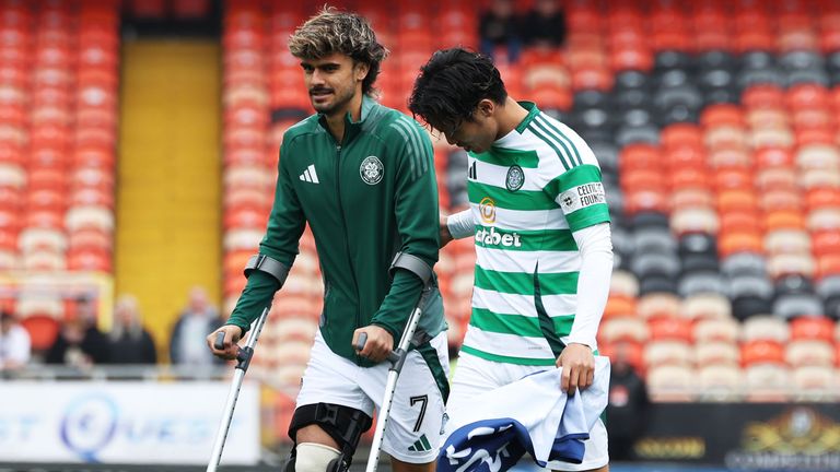 DUNDEE, SCOTLAND - APRIL 26: Celtic's Jota on crutches alongside Reo Hatate during a William Hill Premiership match between Dundee Utd and Celtic at the CalForth Construction Arena at Tannadice Park, on April 26, 2025, in Dundee, Scotland. (Photo by Craig Foy / SNS Group)