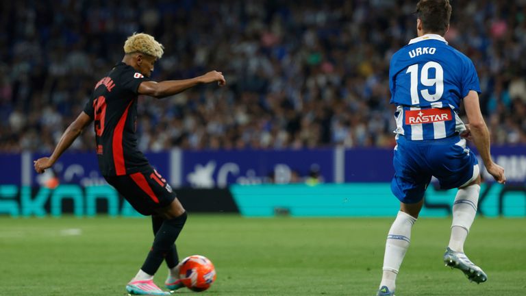 Barcelona's Lamine Yamal, left, scores his side's opening goal during a Spanish La Liga soccer match between Barcelona and Espanyol at Lluis Companys Olympic Stadium in Barcelona, Spain, Thursday, May 15, 2025. (AP Photo/Joan Monfort)