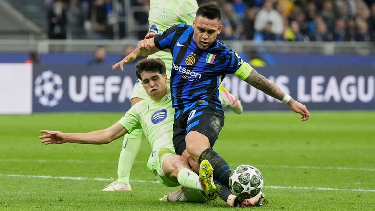 Inter Milan's Lautaro Martinez, right, is fouled by Barcelona's Pau Cubarsi to give away a penalty, during the Champions League semifinal second leg soccer match between Inter Milan and Barcelona at San Siro stadium in Milan , Italy, Tuesday, May 6, 2025. (AP Photo/Luca Bruno)