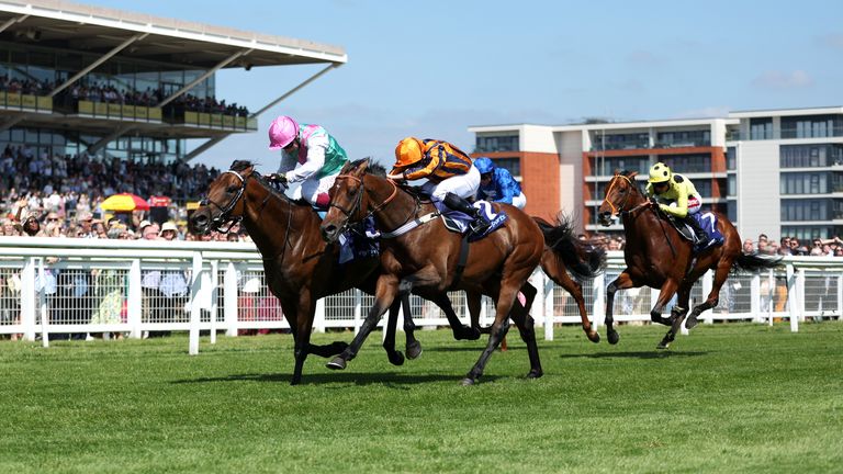 Lead Artist tussles with Dancing Gemini on his way to landing the Group One Lockinge Stakes at Newbury.