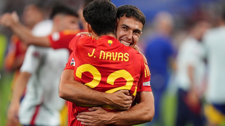 Martin Zubimendi celebrates with Jesus Navas after Spain beat England