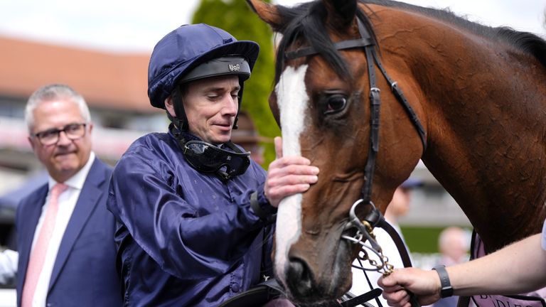 Ryan Moore gives Kilimanjaro Mountain a pat after Dee's victory