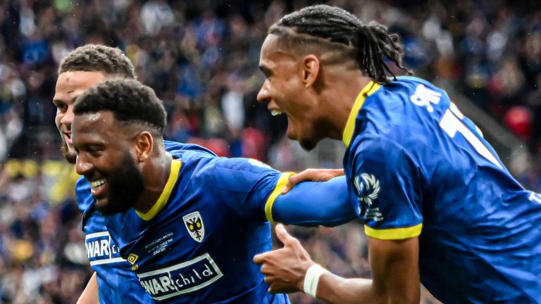 Myles Hippolyte celebrates after scoring for Wimbledon against Walsall in the League Two play-off final