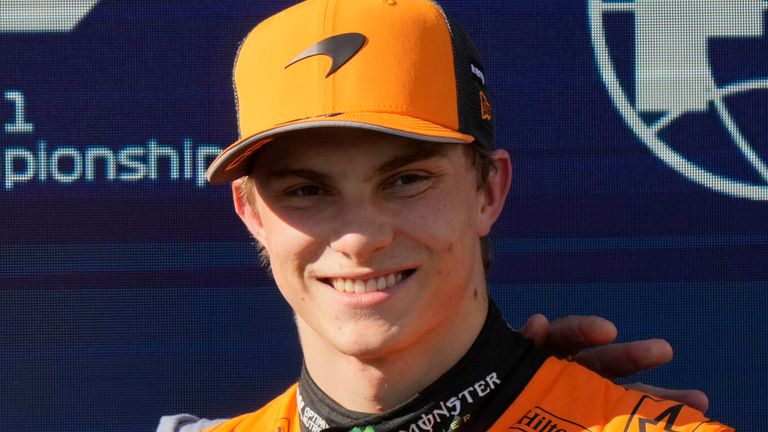 Italian singer Gianni Morandi hugs McLaren driver Oscar Piastri of Australia holds set pole position trophy after the qualifying session ahead of the Italy's Emilia Romagna Formula One Grand Prix, at the Enzo and Dino Ferrari racetrack in Imola, Italy, Saturday, May 17, 2025. (AP Photo/Luca Bruno)