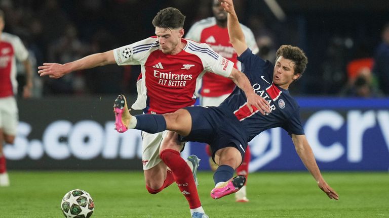 PSG's Joao Neves, right, challenges Arsenal's Declan Rice during the Champions League semifinal, second leg soccer match between Paris Saint-Germain and Arsenal at the Parc des Princes in Paris, Wednesday, May 7, 2025. (AP Photo/Thibault Camus)