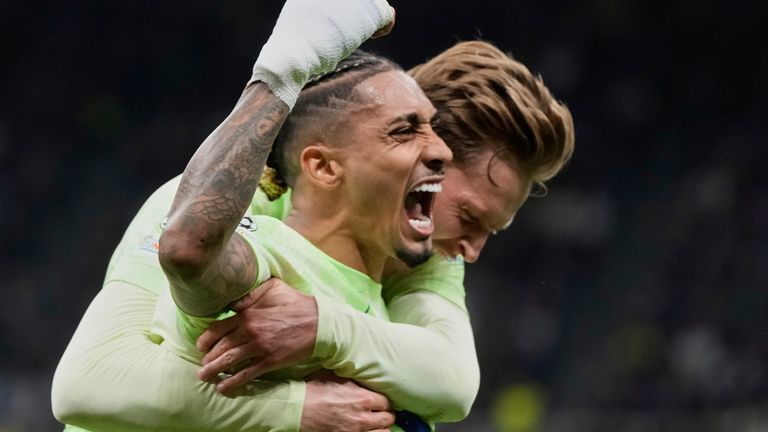 Barcelona's Raphinha, left, celebrates after scoring his side's third goal during the Champions League semifinal second leg soccer match between Inter Milan and Barcelona at San Siro stadium in Milan , Italy, Tuesday, May 6, 2025. (AP Photo/Luca Bruno)