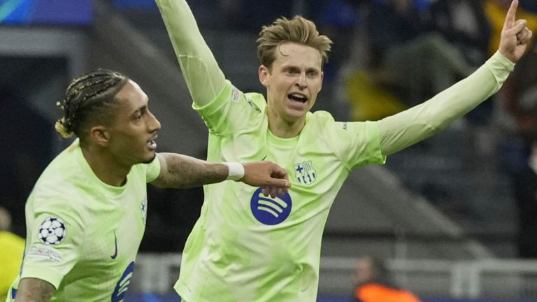 Barcelona's Raphinha, left, celebrates after scoring his side's third goal during the Champions League semifinal second leg soccer match between Inter Milan and Barcelona at San Siro stadium in Milan , Italy, Tuesday, May 6, 2025. (AP Photo/Luca Bruno)