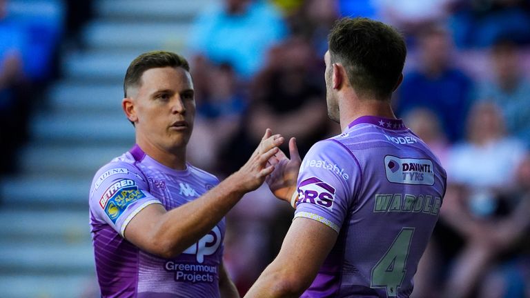 Picture by Olly Hassell/SWpix.com - 16/05/2025 - Rugby League - Betfred Super League Round 11 - Wigan Warriors v Leigh Leopards - The Brick Community Stadium, Wigan, England -Jake Wardle of Wigan celebrating his try with Jai Field of Wigan