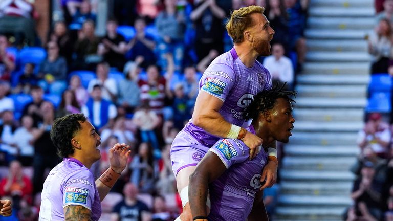 Picture by Olly Hassell/SWpix.com - 16/05/2025 - Rugby League - Betfred Super League Round 11 - Wigan Warriors v Leigh Leopards - The Brick Community Stadium, Wigan, England - Junior Nsemba of Wigan celebrating his try with Adam Keighran of Wigan