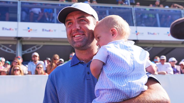 Scottie Scheffler holds his son Bennett after winning the CJ BYRON Nelson Cup