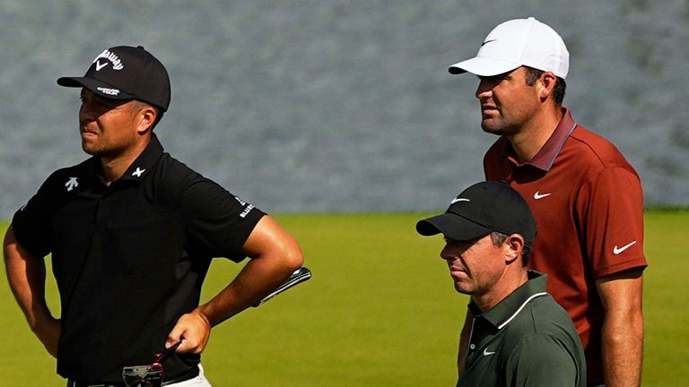 Xander Schauffele, Rory McIlroy, of Northern Ireland, and Scottie Scheffler line up a their putts on the 14th hole during the first round of the PGA Championship golf tournament at the Quail Hollow Club, Thursday, May 15, 2025, in Charlotte, N.C. (AP Photo/David J. Phillip) 