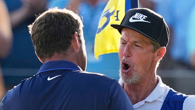 Scottie Scheffler hugs his caddie Ted Scott after winning the PGA Championship golf tournament at the Quail Hollow Club, Sunday, May 18, 2025, in Charlotte, N.C. (AP Photo/David J. Phillip) 
