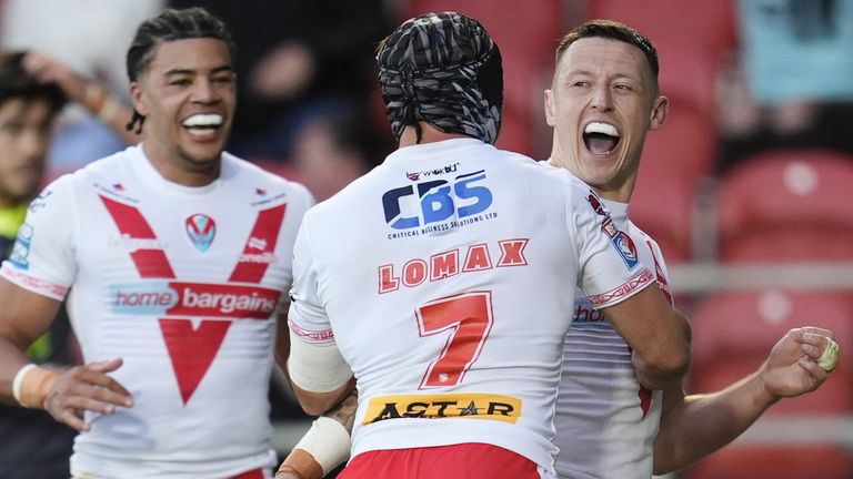 St Helens' Deon Cross (right) celebrates scoring his side's third try against Catalans Dragons
