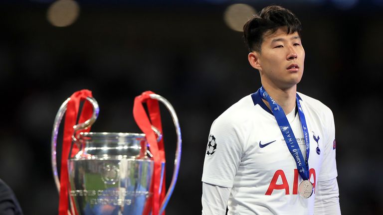 Tottenham Hotspur's Son Heung-min walks past the trophy after collecting his runner's up medal after the UEFA Champions League Final at the Wanda Metropolitano, Madrid.