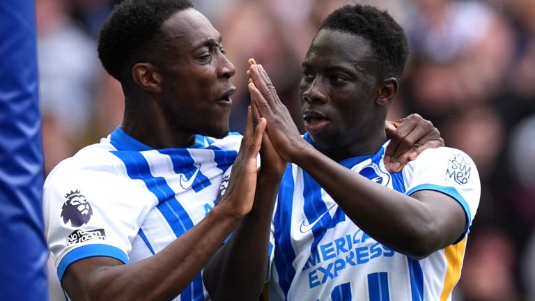 Danny Welbeck celebrates with Yankuba Minteh after his first-half goal against Newcastle