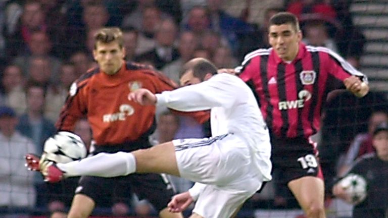 Real Madrid's Zinedine Zidane hits the ball past Bayer Leverkusen's Lucio, right, and goalkeeper Jorg Butt, to score his team's second goal during the UEFA Champions League Final at Hampden Park stadium in Glasgow, Scotland, Wednesday May 15, 2002
