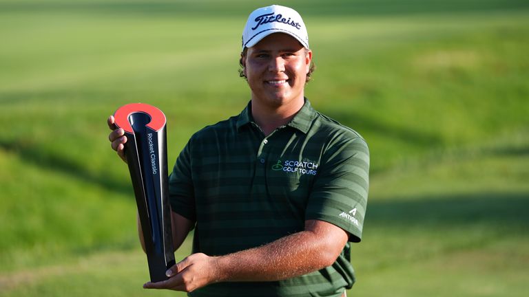 Aldrich Potgieter, of South Africa poses with the trophy after winning a playoff during the final round of the Rocket Classic