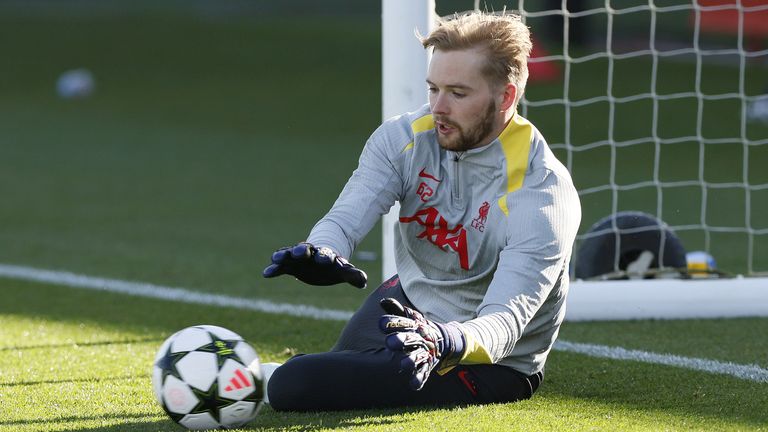Caoimhin Kelleher dives to his left to make a save during Liverpool training before a Champions League tie