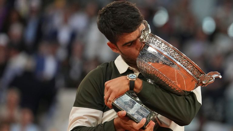 Spain's Carlos Alcaraz celebrates with the trophy after winning the final match of the French Tennis Open against Italy's Jannik Sinner at t