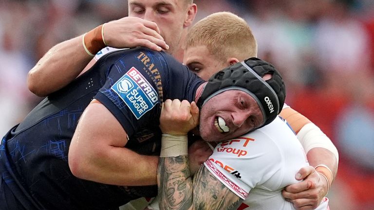 Salford Red Devils 'Chris Hill (Center) is Tackled by St Helens' Morgan Knowles (Left)