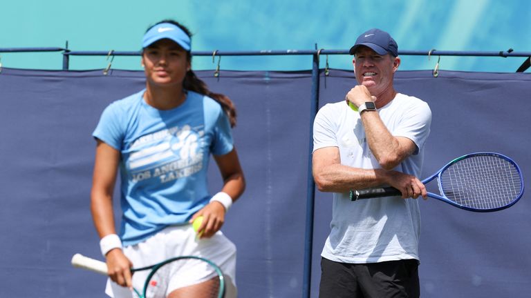 Britain's Emma Raducanu (L) warms up with her coach and British former tennis player Mark Petchey on day one at the Rothesay Eastbourne International tennis tournament in Eastbourne, southern England, on June 23, 2025, on the eve of her women's singles tennis match against Ann Li of the US. (Photo by Adrian Dennis / AFP)