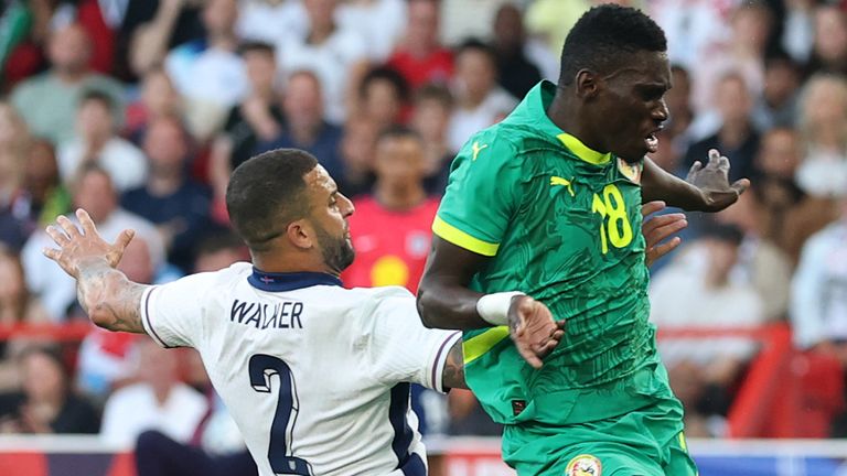 NOTTINGHAM, ENGLAND - JUNE 10: Ismaila Sarr of Senegal scores his team's first goal under pressure from Kyle Walker of England during the in