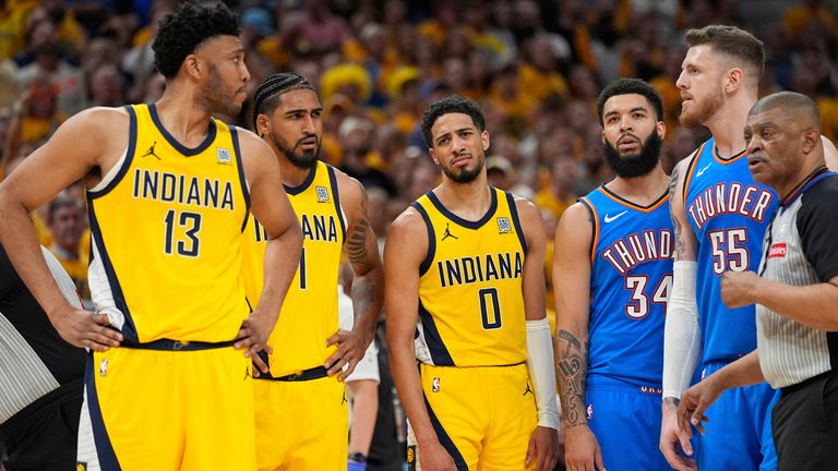 Indiana Pacers center Tony Bradley (13) looks towards Oklahoma City Thunder center Isaiah Hartenstein (55) after a foul as guard Tyrese Haliburton (0) looks toward Bradley during the second half of Game 6 of the NBA Finals basketball series, Thursday, June 19, 2025, in Indianapolis. (AP Photo/Abbie Parr)