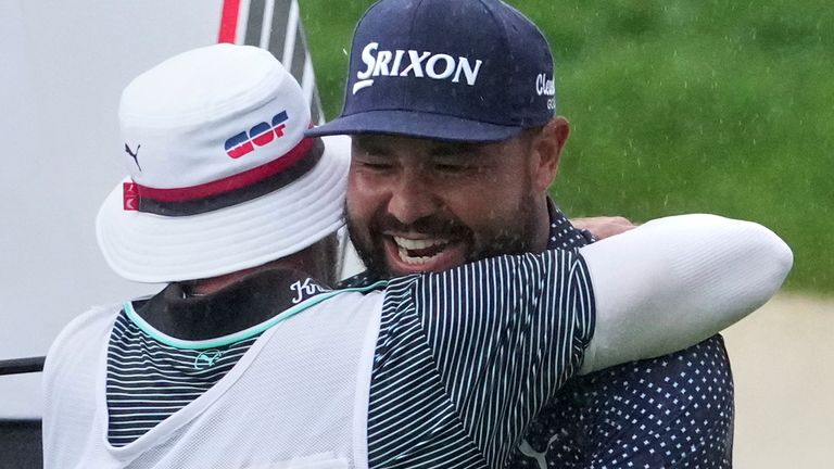 J.J. Spaun celebrates by hugging his caddie, Mark Carens, after making a birdie putt on the 18th hole during the final round of the U.S. Open golf tournament at Oakmont Country Club Sunday, June 15, 2025, in Oakmont, Pa. (AP Photo/Gene J. Puskar)