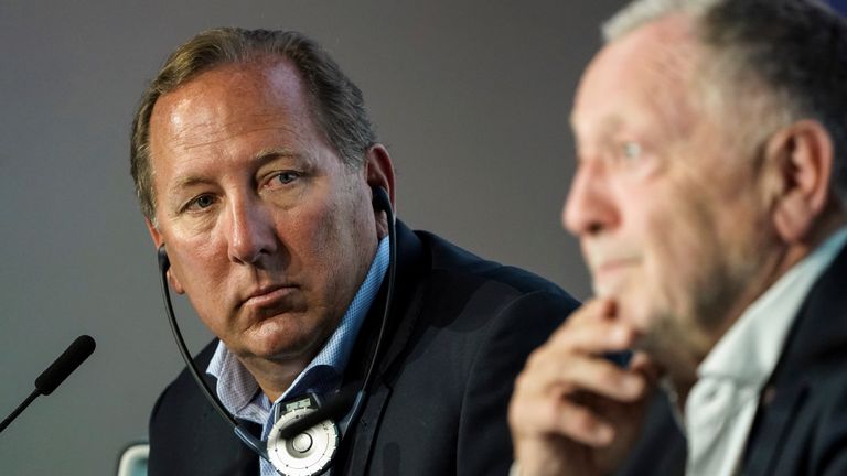 John Textor listens to Lyon president Jean-Michel Aulas during a press conference