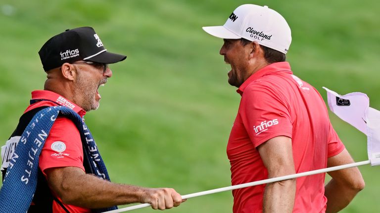 Keegan Bradley, right, celebrates with caddie Scott Vail, left, after winning of the Travelers Championship golf tournament at TPC River Highlands, Sunday, June 22, 2025, in Cromwell, Conn. (AP Photo/Jessica Hill)