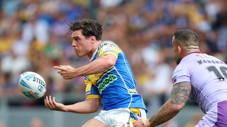 Brodie Croft (left) of Leeds Rhinos and Paul Vaughan in action by Warrington Wolves during the Betfred Super League
