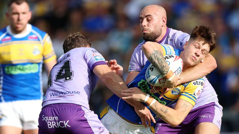 Riley Lumb (in the center) of Leeds Rhinos is covered by Sam Powell of Warrington Wolves (Center on the left) and James Harrison 