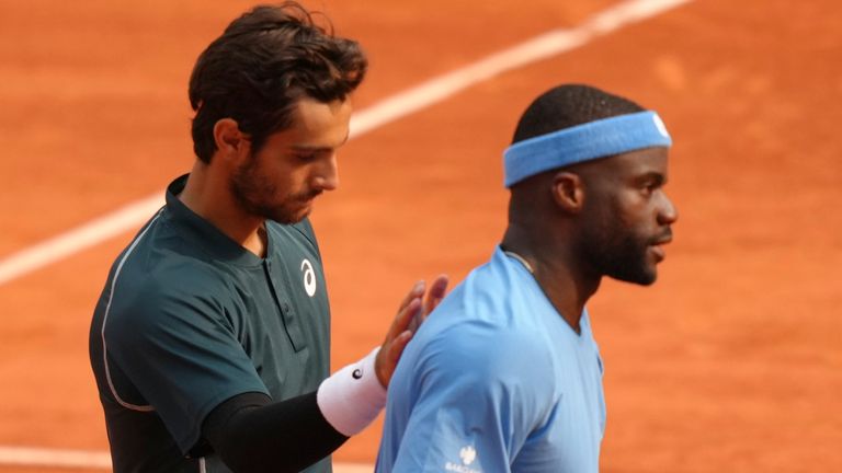 Winner Italy's Lorenzo Musetti, left, and Frances Tiafoe of the U.S. walk after their quarterfinal match of the French Tennis Open at the Roland-Garros stadium in Paris, Tuesday, June 3, 2025. (AP Photo/Aurelien Morissard)
