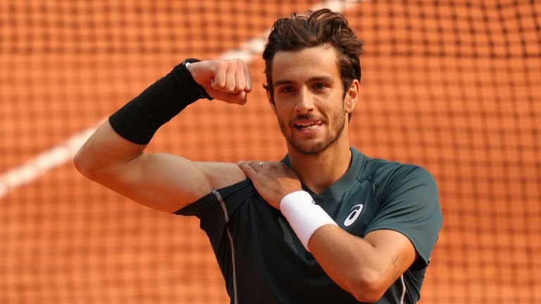 Italy's Lorenzo Musetti celebrates as he won the quarterfinal match of the French Tennis Open against Frances Tiafoe of the U.S. at the Rola