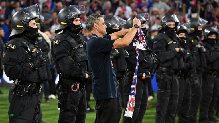 Luis Enrique celebrates with PSG fans in Rapid Reaction Police