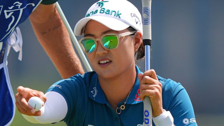 Minjee Lee, right, and her caddie Michael Paterson strategize for a putt on the first green during the final round of the Women's PGA Championship golf tournament Sunday, June 22, 2025, in Frisco, Texas. (AP Photo/LM Otero)